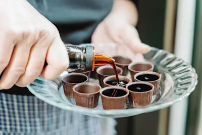 Shots of homemade Ginjinha being poured.