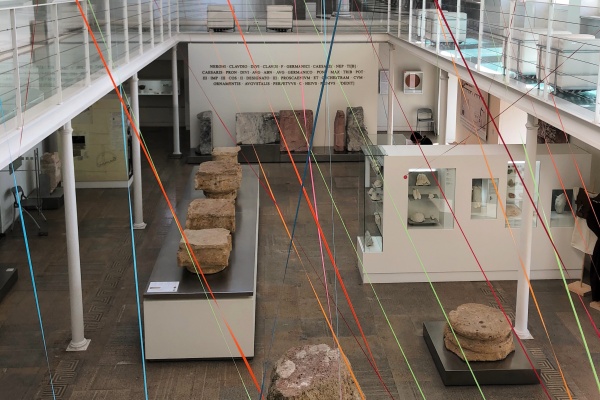 Inside Museu do Teatro Romano in Lisbon where intertwined colorful threads represent the cultural layers and influences in Lisbon.